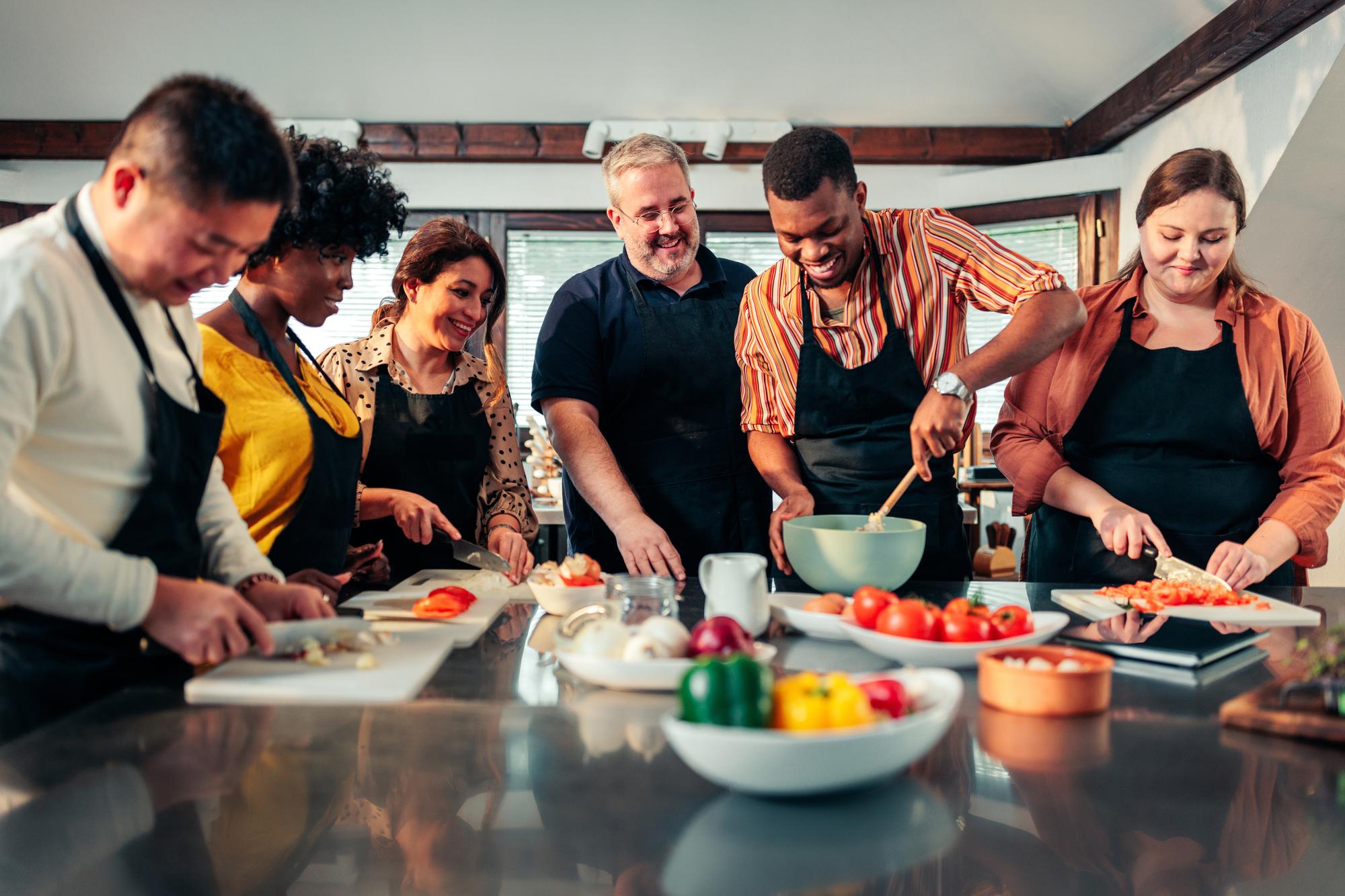 Workshop table with attendees and chef demonstration